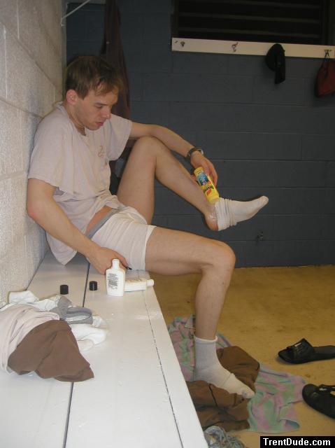 Applying Desenex Antifungal powder to his foot to prevent athlete's foot (Miconazole Nitrate)