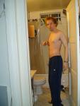A goatee, shirtless, and Addidas blue sweat pants