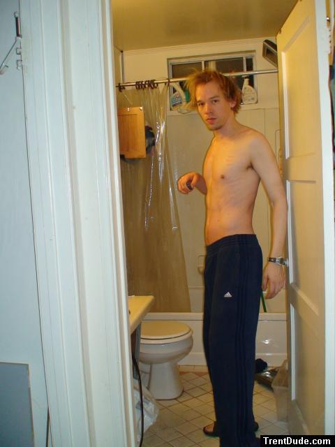 A goatee, shirtless, and Addidas blue sweat pants