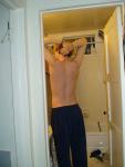 Stretching wearing Addidas sweat pants (back)