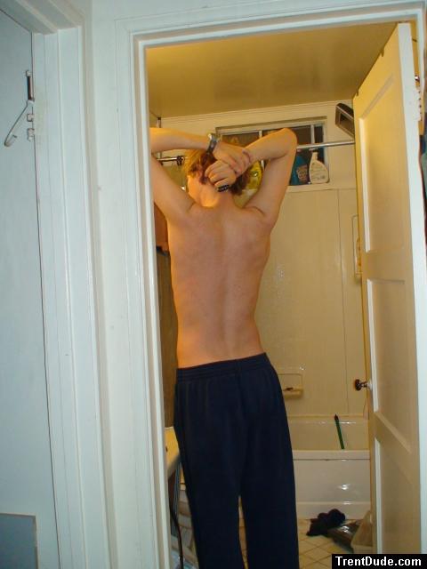 Stretching wearing Addidas sweat pants (back)