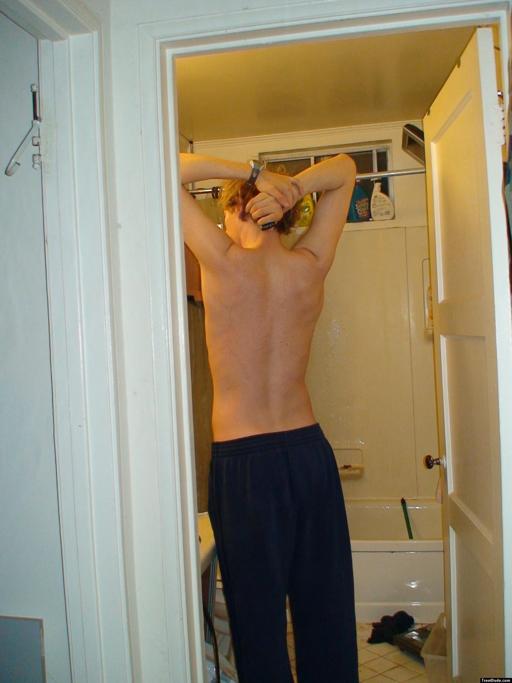 Stretching wearing Addidas sweat pants (back)