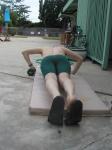 push-ups in a Nike green swim jammer