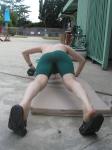 push-ups in a Nike green swim jammer