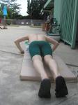 push-ups in a Nike green swim jammer