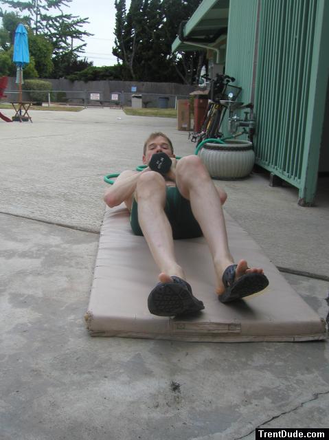 Crunches in a Nike swim jammer, toes in Nike slippers