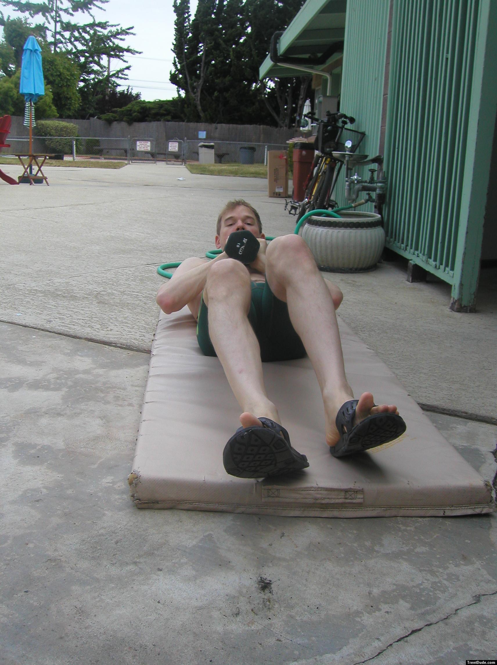 Crunches in a Nike swim jammer, toes in Nike slippers