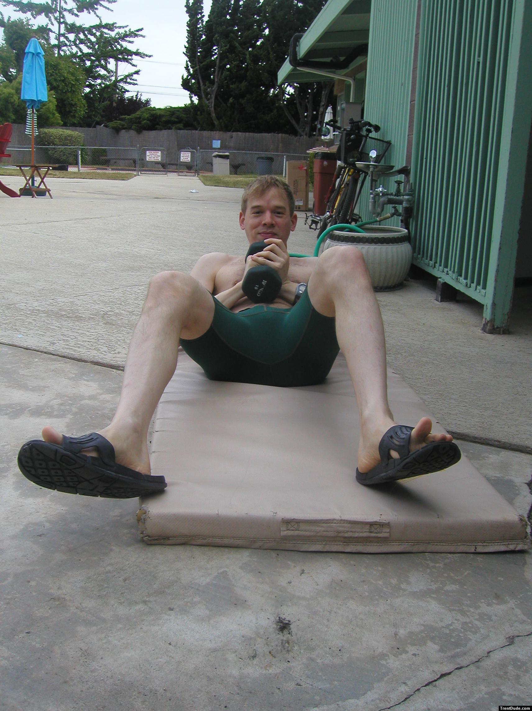 Crunches in a Nike swim jammer, toes in Nike slippers