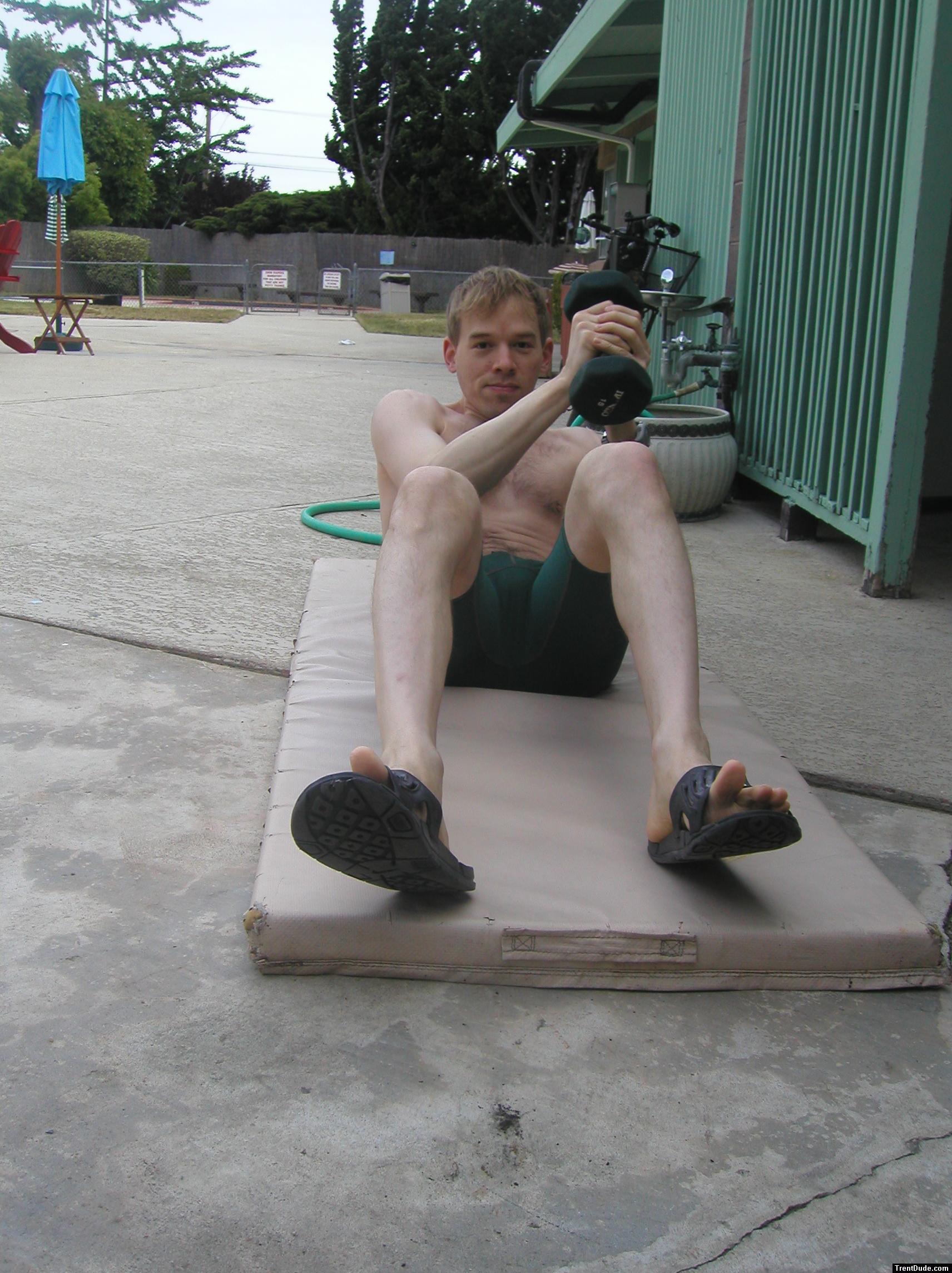 Crunches in a Nike swim jammer, toes in Nike slippers