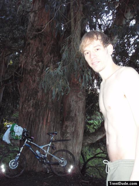 Green FILA sweat pants - standing near a bike and a large tree (goatee) (bets)