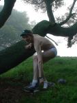Smiling in underwear near a mossy tree